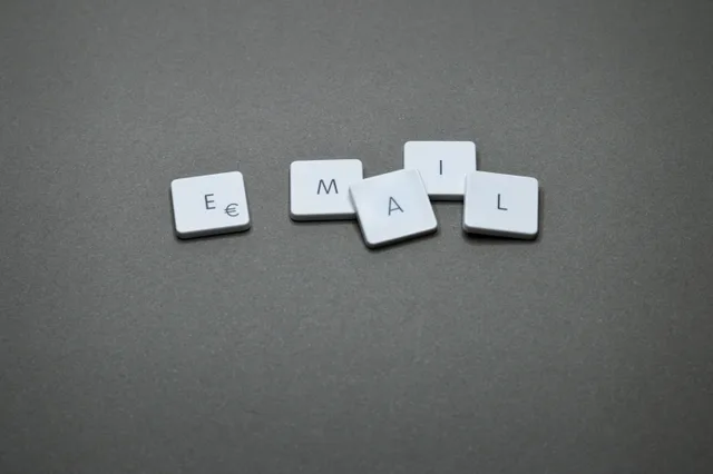 Close-up of the word 'email' formed with letter tiles on a gray surface. How to improve startup email marketing: audit, authenticate, measure