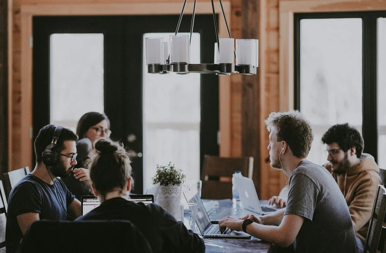 work meeting, office, collaboration, laptop, headphones, modern, discussion, man, woman, youth, creativity, technology, café, teamwork, modern office, group work, interior, light, people. How to read product-led growth for startups case studies