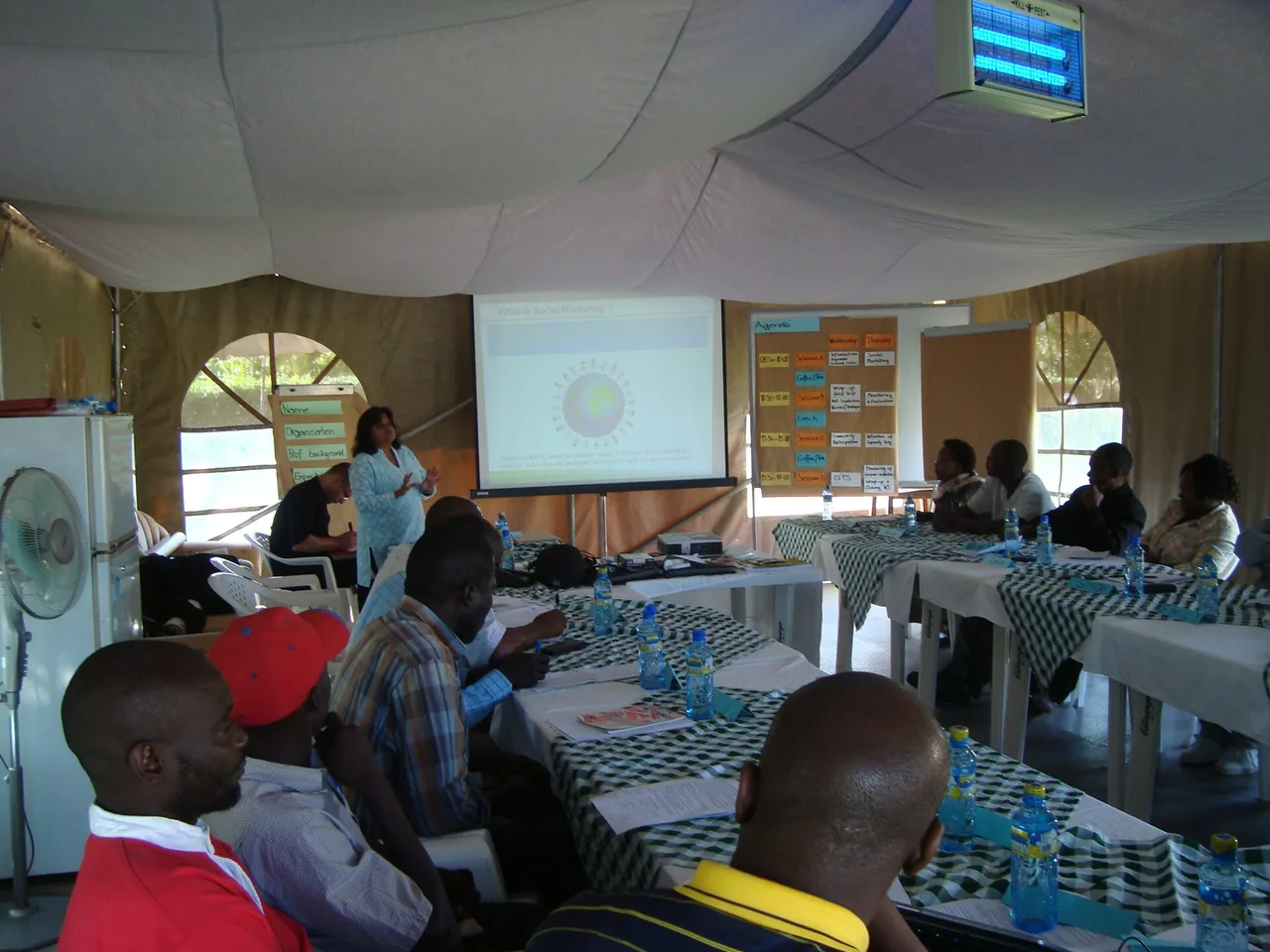 A presenter leads a social marketing workshop for seated participants.
